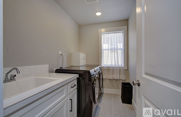A modern laundry room with a washer and dryer.
