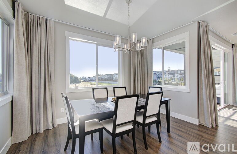 A dining room with a table set for four.