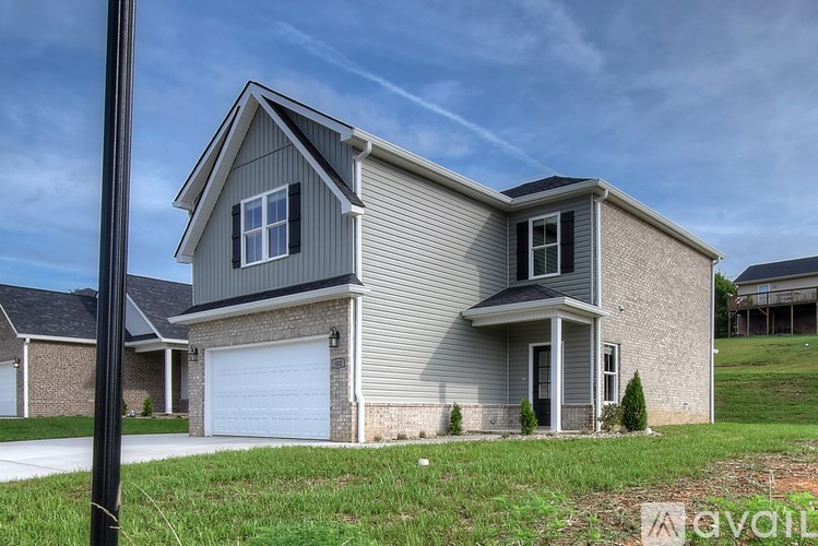 A modern house with a garage is for sale.