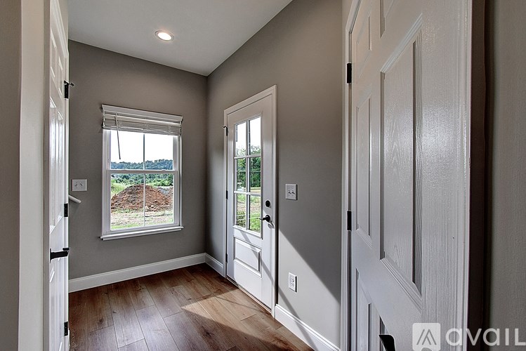 A room with a window and a door.