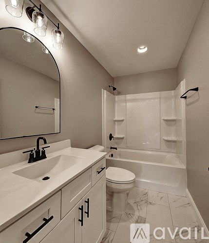 A bathroom with a sink, toilet, and bathtub.