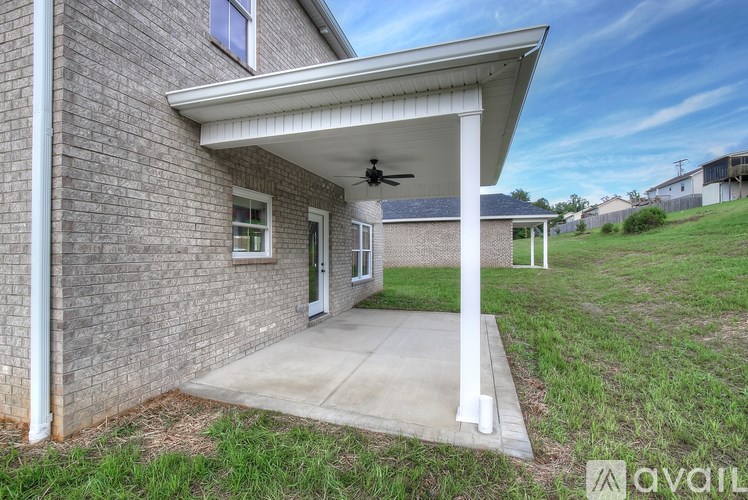 A house with a covered patio and a ceiling fan.