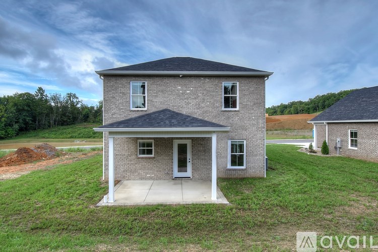 A two-story house with a front porch is for sale.