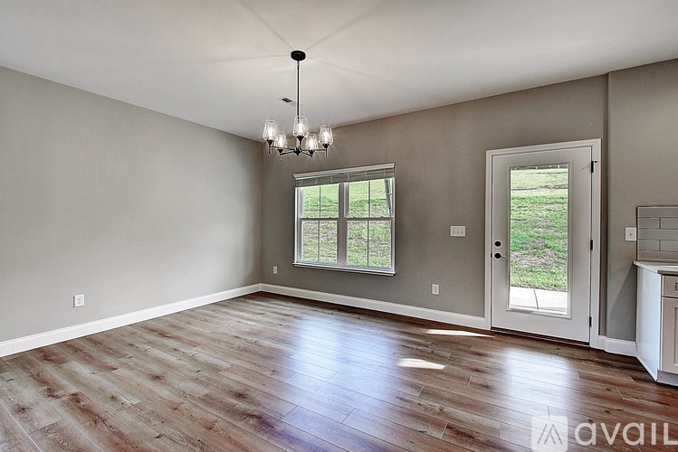 A room with a wooden floor and a chandelier.