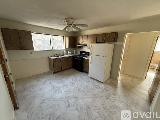 A kitchen with a refrigerator, stove, and oven.