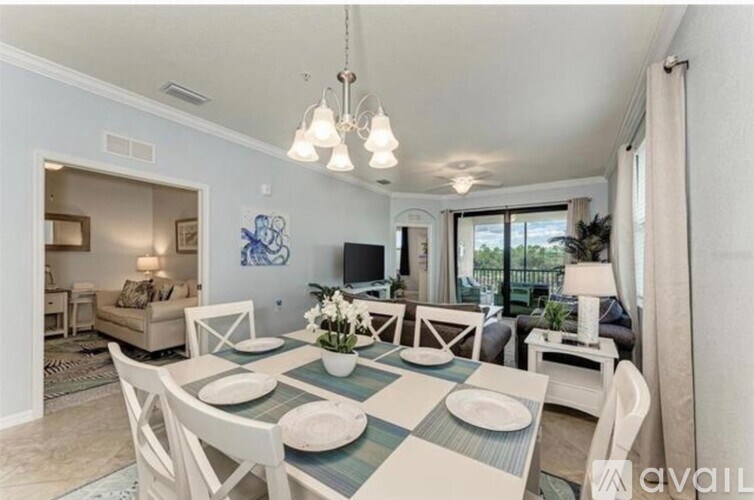 A dining room with a checkered table and white chairs.