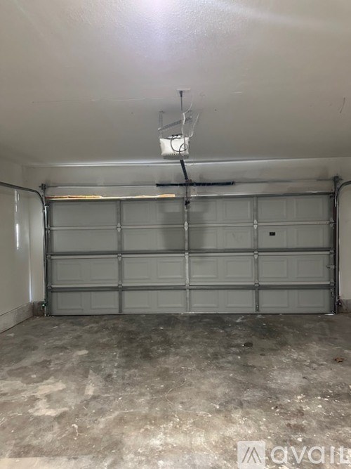 Garage with a basketball hoop hanging from the ceiling.