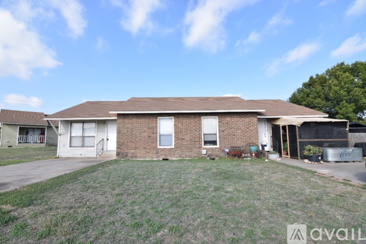 A house with a brown roof and a white garage door.
