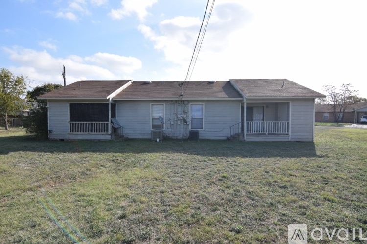 A house with a brown roof and a white garage door is in the image.