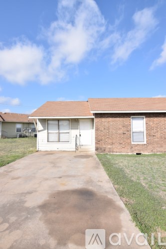 A house with a brown roof and a white door is shown.