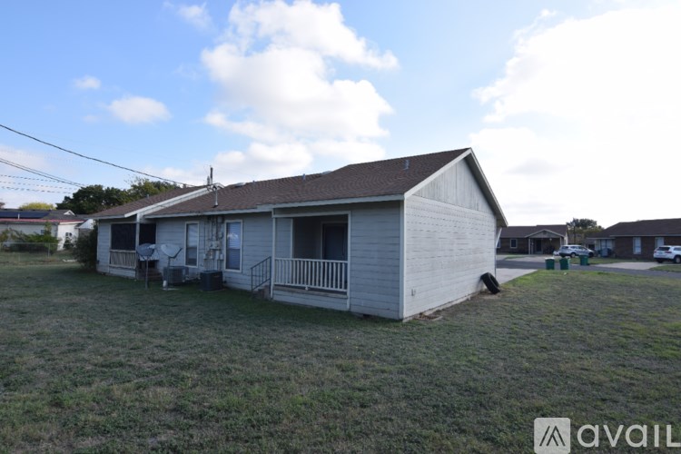 A house with a porch and a covered patio is available for rent.