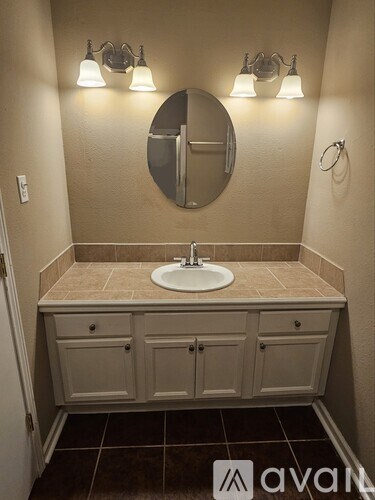 A bathroom with a sink and a mirror above it.