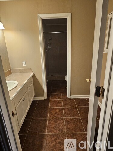 A bathroom with a sink, toilet and shower.