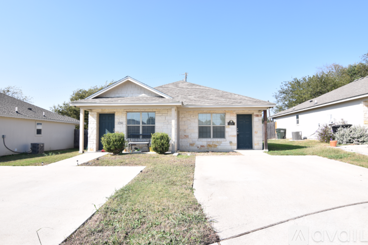 A house with a front yard and a driveway.