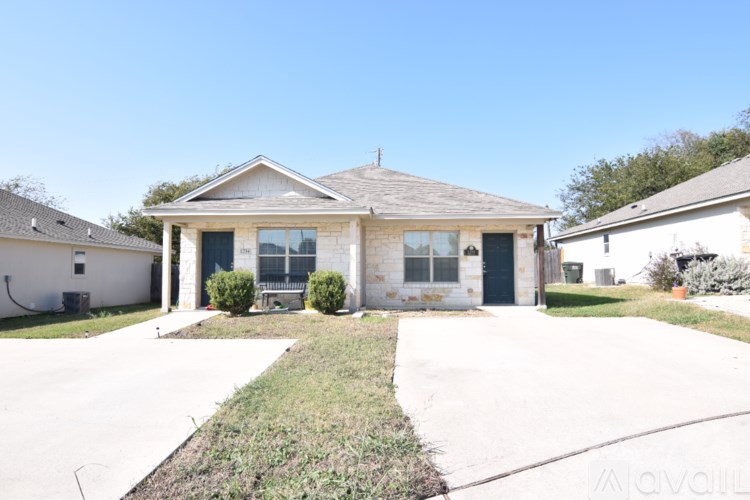 A house with a front yard and a driveway.