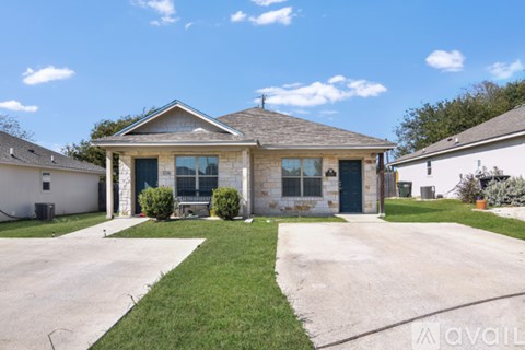 A house with a front yard and a driveway.