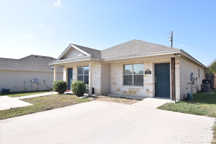 A house with a blue door and a grey roof.