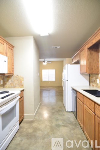 A kitchen with wooden cabinets and a white refrigerator.