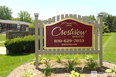 A sign for Crestview Estates with a phone number and website on it.