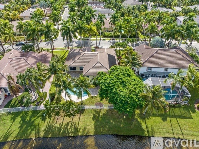 A bird's eye view of a neighborhood with palm trees and houses.