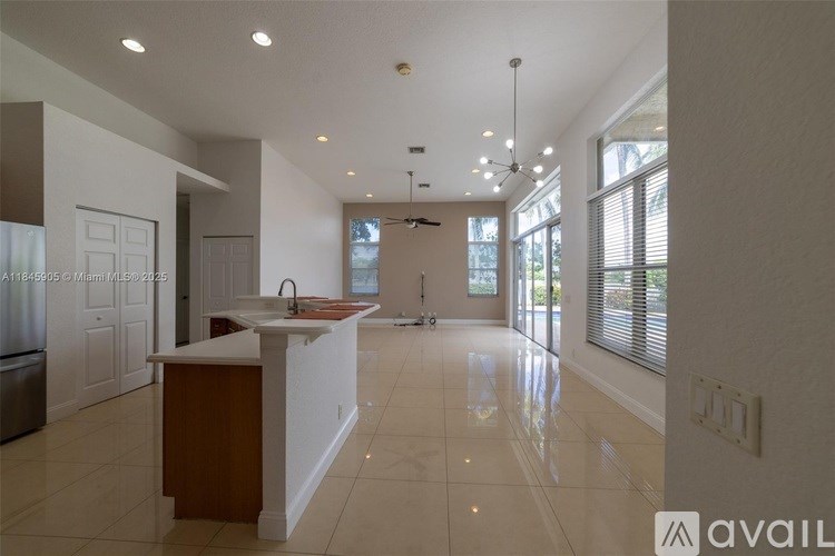 A kitchen with white cabinets and a wooden island.