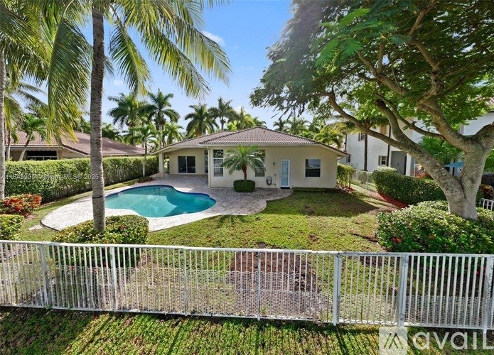 A house with a pool surrounded by a fence.