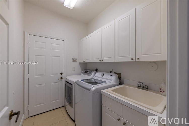 A small laundry room with a washer and dryer.