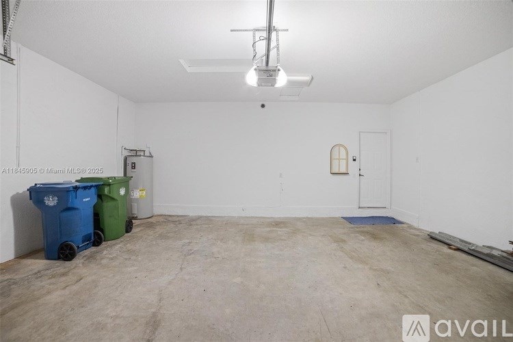 A room with a white wall and a door is available for rent.