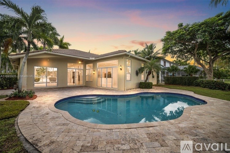 A house with a swimming pool in front of it.