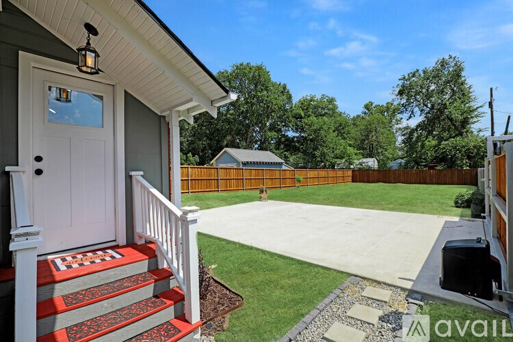 A house with a white door and a red and grey staircase.