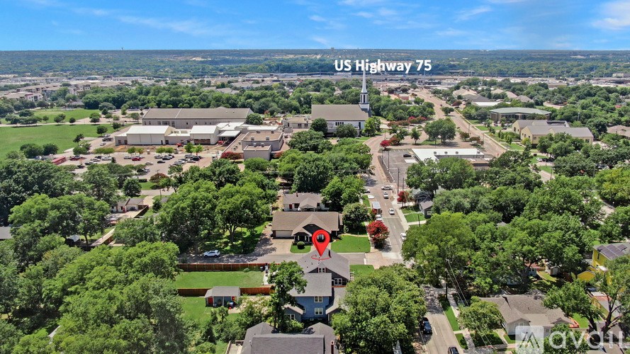 An aerial view of a neighborhood with a sign that reads "US Highway 75".