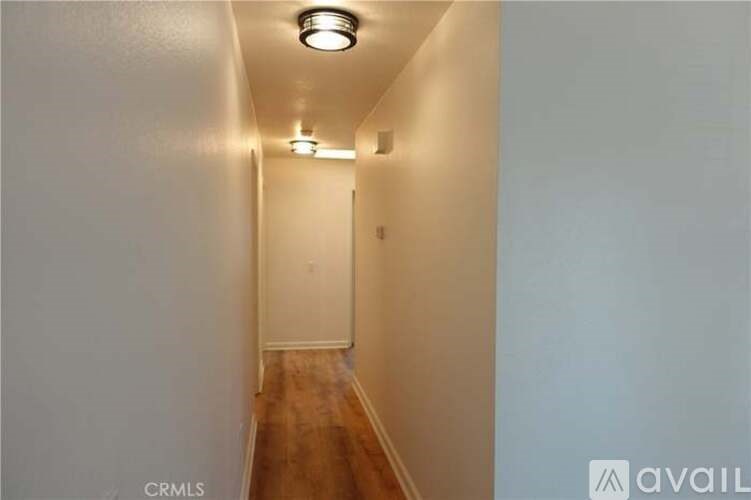 A long hallway with a light on the ceiling.