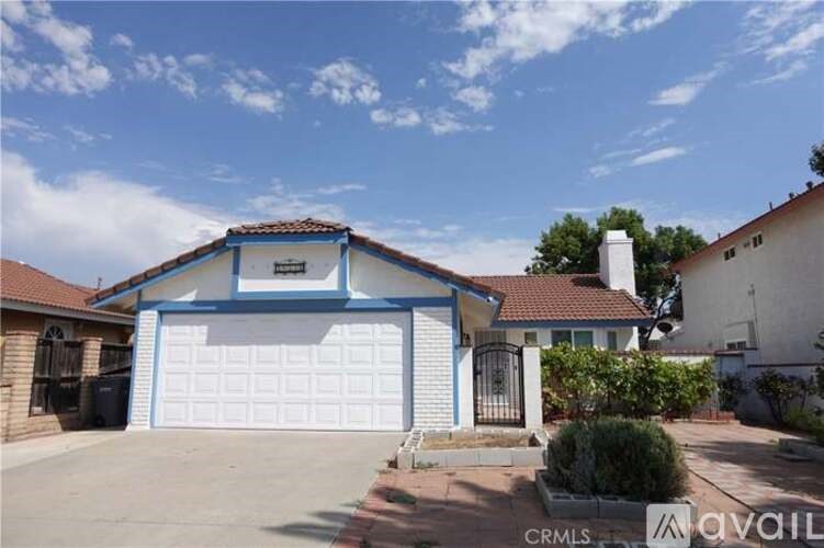 A house with a blue garage door is for sale.