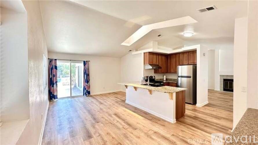 A spacious kitchen with wooden floors and a large island.