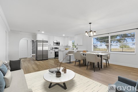 A modern kitchen with a dining table and chairs.