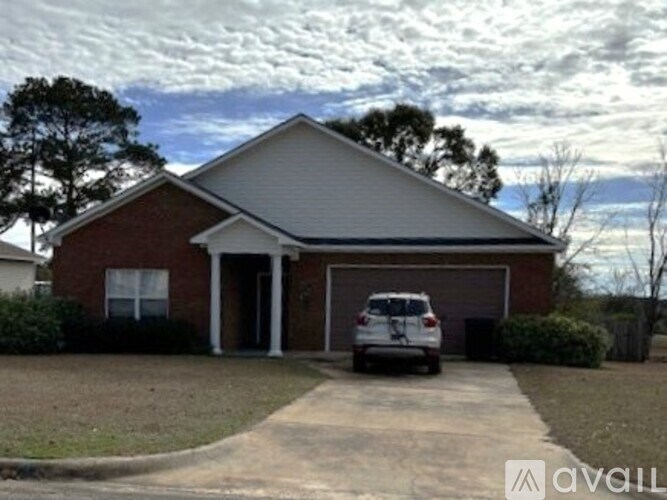 A house with a car parked in front.
