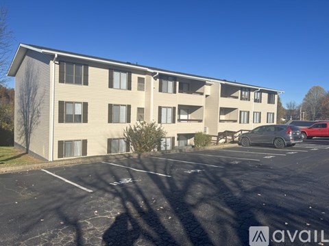 A large building with a parking lot in front of it.