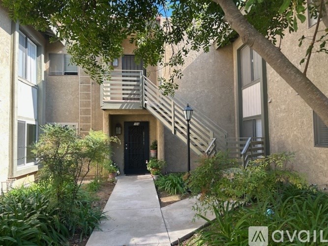 A building with a black door and a staircase leading to the entrance.