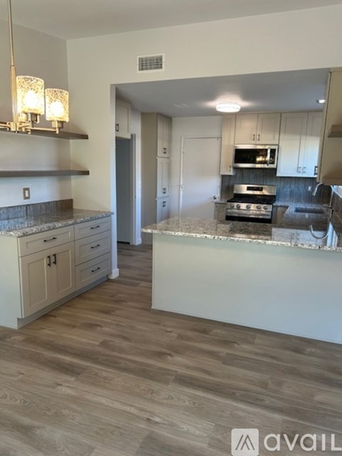 A kitchen with a countertop and a stove top oven.