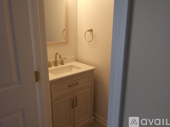 A bathroom with a sink and a mirror.
