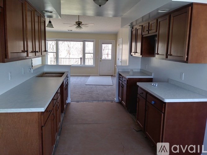 A kitchen with brown cabinets and a white countertop.
