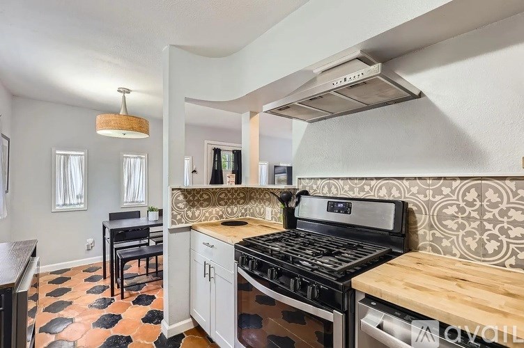 A kitchen with a black and white checkered floor.