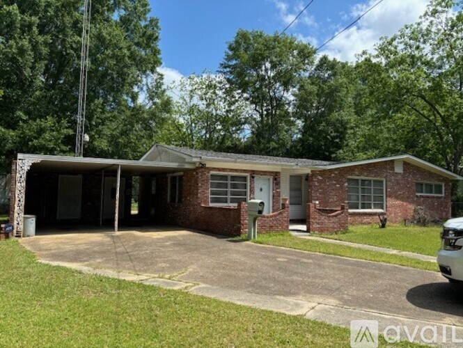 A house with a driveway and a car parked in front.