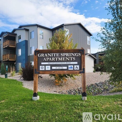 A sign for Granite Springs Apartments stands in front of apartment buildings.
