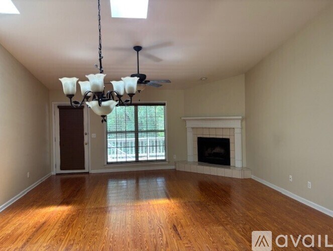 A room with a fireplace and a chandelier.