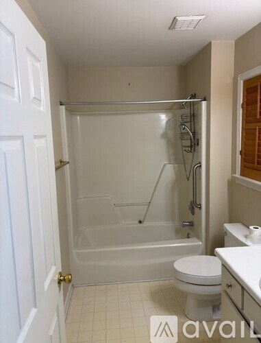 A bathroom with a toilet, sink, and walk-in shower.