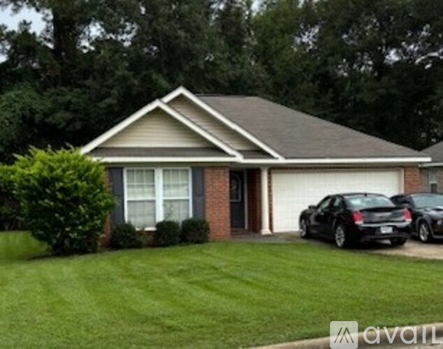 A house with a grey roof and a white garage door.