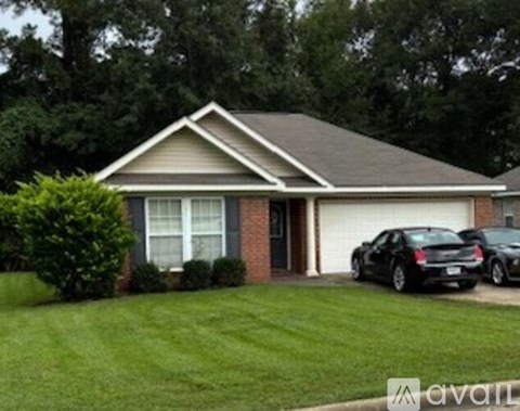 A house with a grey roof and a white garage door.