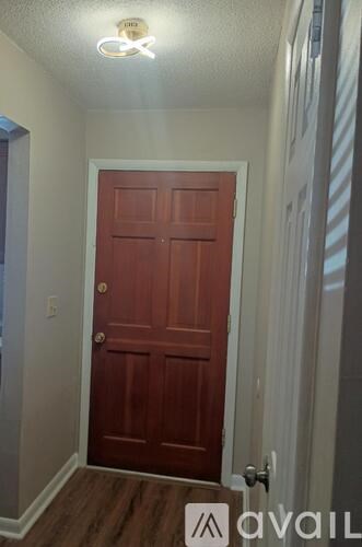 A red door in a room with a white ceiling.