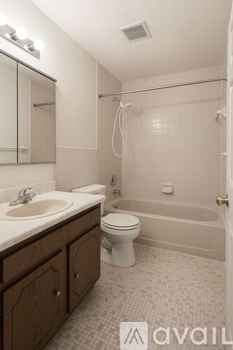 A bathroom with a toilet, sink, and bathtub.